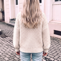 Biały sweter damski oversize z golfem na modelce, widok z tyłu